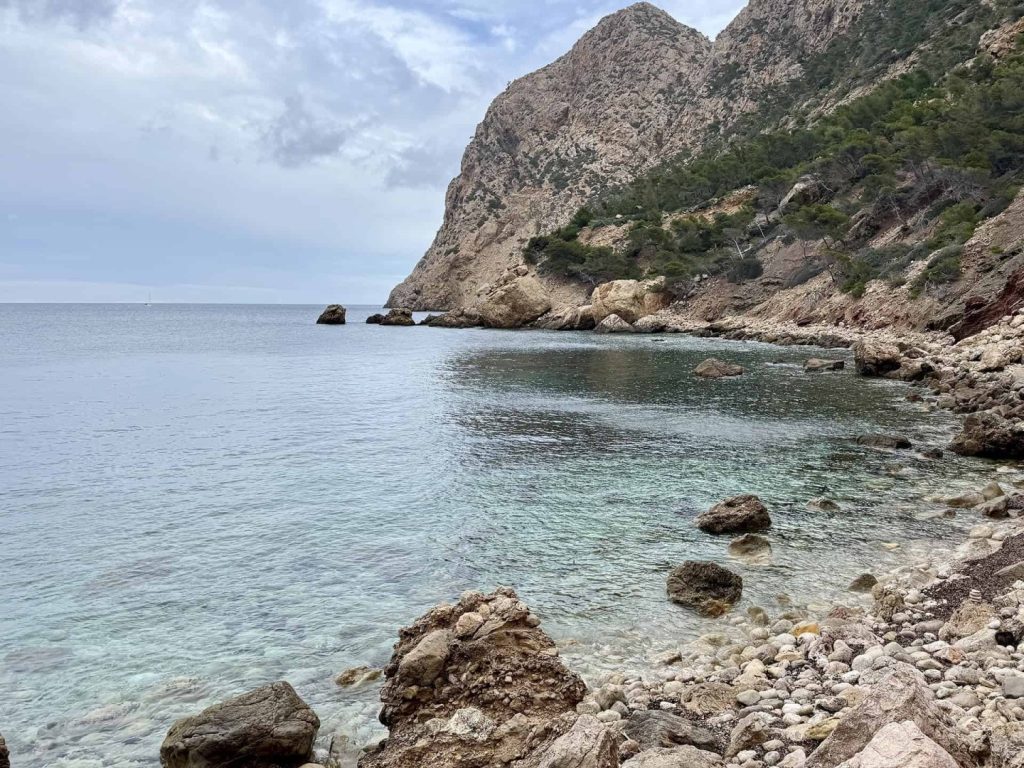 Elm Hike Mallorca: rocky beach with clear water, coastal cliffs and scenic Mediterranean shoreline views