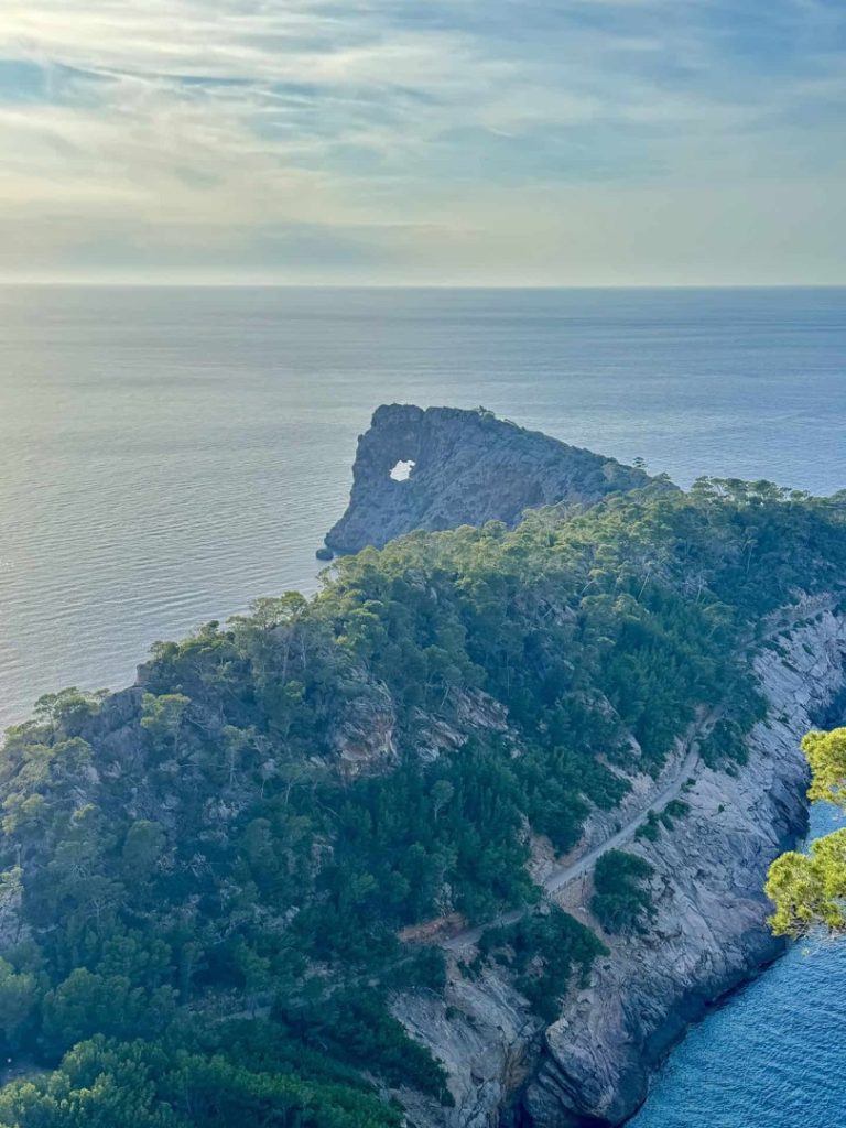 Foradada Hike Mallorca: coastal ridge with natural rock arch, sea views and scenic Tramuntana landscape